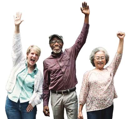 Three older people smiling and waving or raising their fists